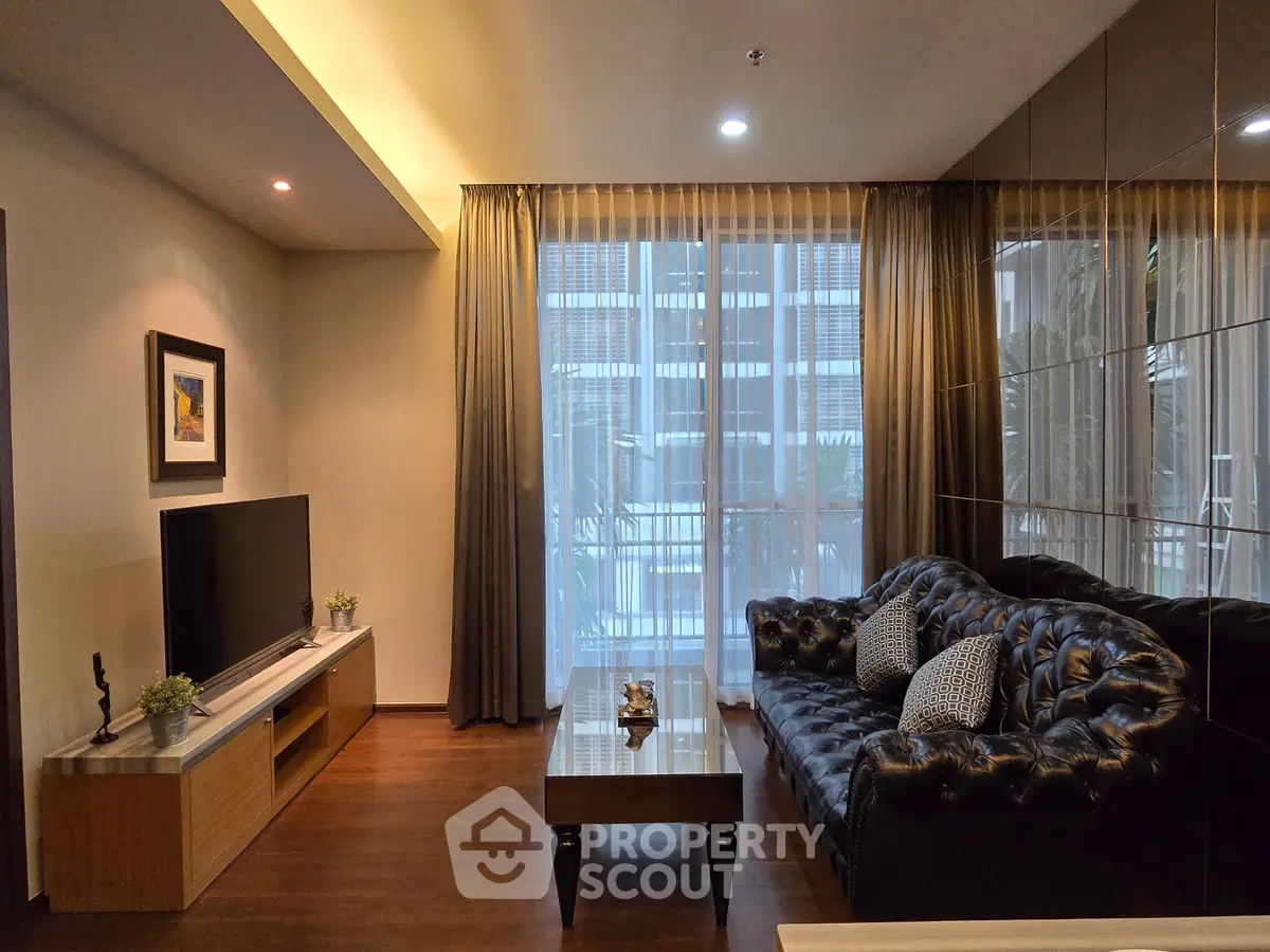 Elegant living room with modern decor, plush sofa, and large window for natural light.