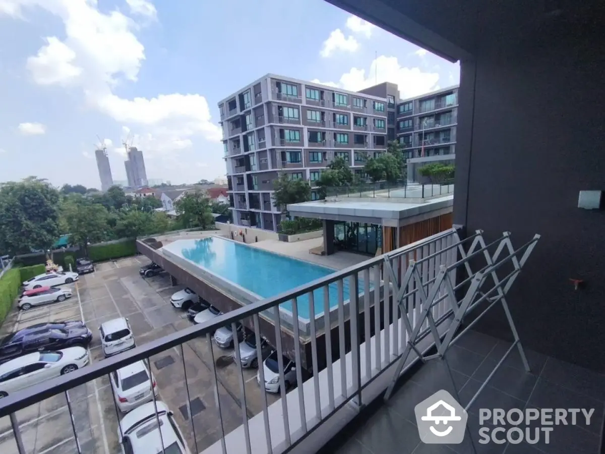 Modern apartment with pool view from balcony, perfect for urban living.