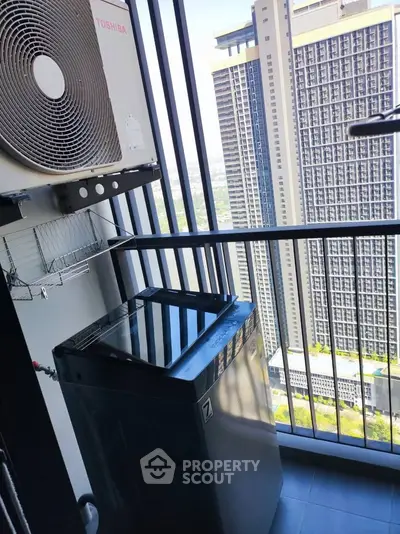 Modern balcony with city view, featuring air conditioning unit and washing machine, perfect for urban living.