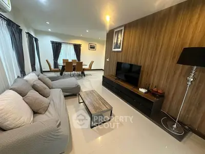 Spacious modern living room with elegant decor and dining area, perfect for family gatherings.