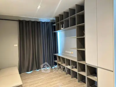 Modern living room with sleek shelving and floor-to-ceiling curtains