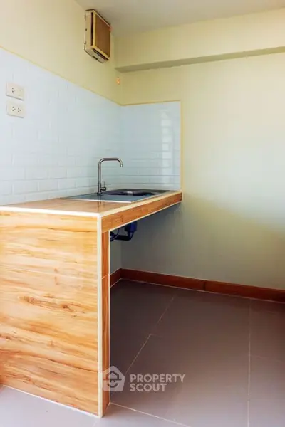 Modern kitchen with sleek wooden cabinetry and minimalist design, perfect for urban living.