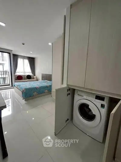 Modern studio apartment with built-in washing machine and stylish decor