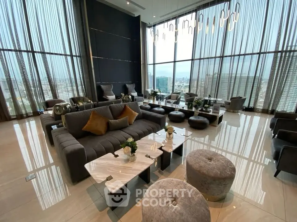Luxurious high-rise living room with panoramic city views and elegant modern furnishings.