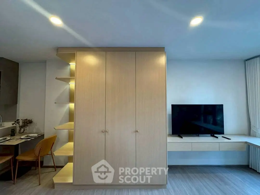 Modern living room with sleek TV setup and stylish wooden cabinetry