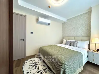 Cozy bedroom with modern decor and air conditioning in a stylish apartment.