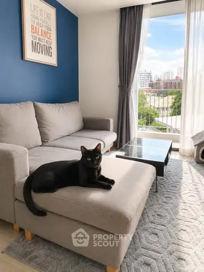 Modern living room with stylish decor and a cozy sofa, featuring a large window with city views.