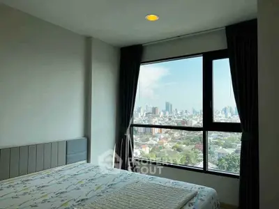 Modern bedroom with large window offering stunning cityscape views, perfect for urban living.