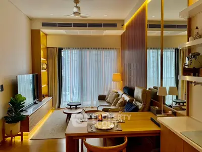 Modern living room with elegant decor, cozy seating, and ambient lighting in a stylish apartment.