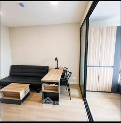 Modern living room with sleek furniture and wooden flooring in a stylish apartment.