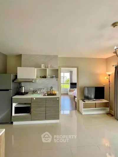 Modern open-plan kitchen and living area with sleek design and natural light.