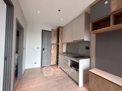 Modern kitchen with sleek cabinetry and wooden accents, featuring a minimalist design and ample storage space.
