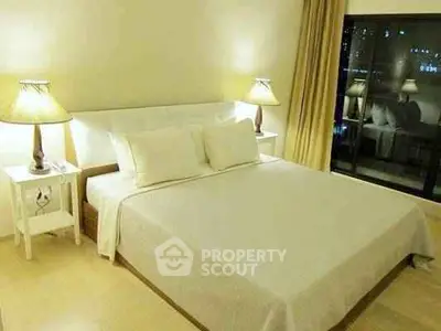 Spacious bedroom with elegant lighting and large window view