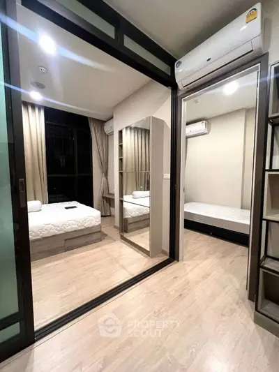 Modern dual-bedroom apartment with sleek design and air conditioning, featuring wooden flooring and ample natural light.