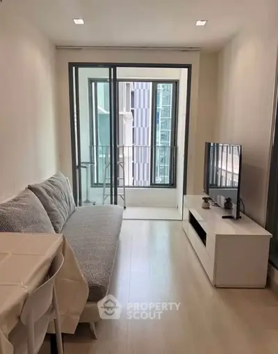 Modern living room with balcony view in a high-rise apartment