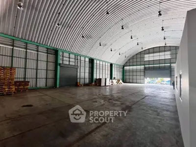 Spacious industrial warehouse with high ceilings and ample storage space.