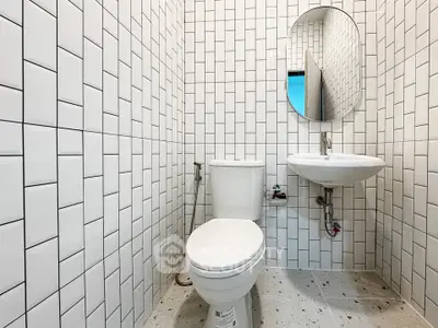 Modern bathroom with white tiled walls and sleek fixtures