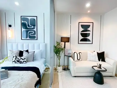 Modern bedroom and living area with stylish decor and cozy ambiance.
