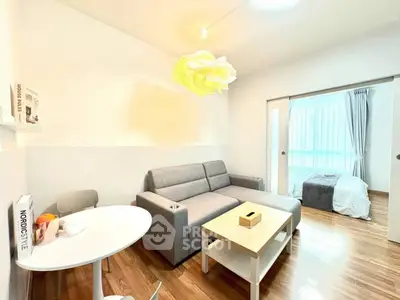 Modern living room with cozy sofa and dining area, featuring wooden flooring and stylish decor.