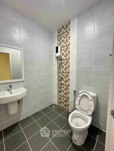 Modern bathroom with sleek tiles and contemporary fixtures, perfect for a stylish home.