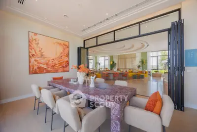 Luxurious dining area with elegant marble table and stylish decor in a modern open-plan living space.