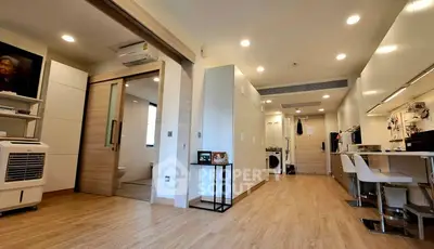 Modern open-plan living space with sleek kitchen and wooden flooring