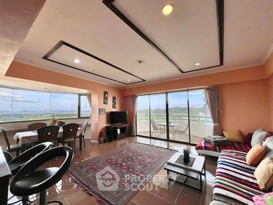 Spacious living room with panoramic views and stylish decor in modern apartment.