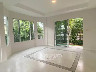 Spacious living room with large windows and garden view in modern home
