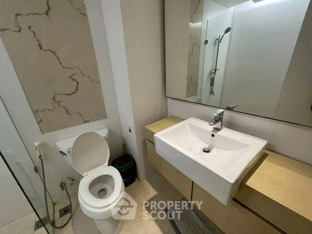 Modern bathroom with sleek fixtures and large mirror