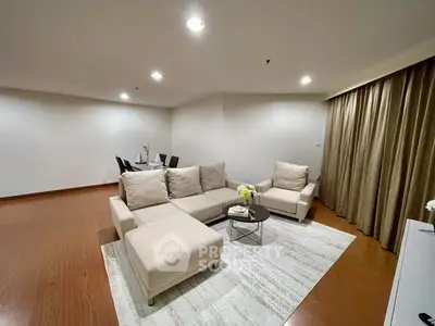 Spacious modern living room with elegant furniture and dining area, perfect for entertaining guests.