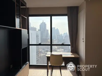 Modern study room with city view, featuring a sleek desk and chair by a large window.