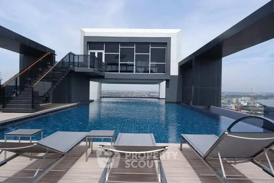 Luxurious rooftop pool with modern architecture and stunning city views, perfect for relaxation and leisure.