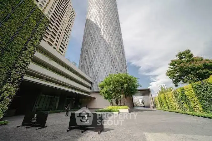 Stunning modern building exterior with lush greenery and sleek architectural design.