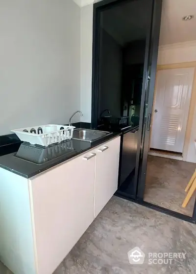 Modern kitchen with sleek countertops and sliding glass door