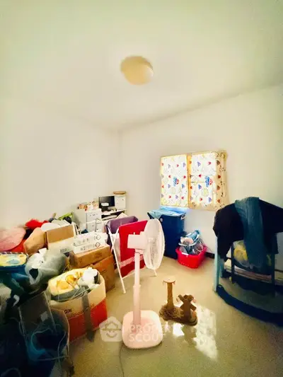 Cozy storage room with natural light and organized boxes, perfect for extra space in your home.