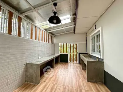 Spacious modern outdoor kitchen with sleek countertops and natural light.
