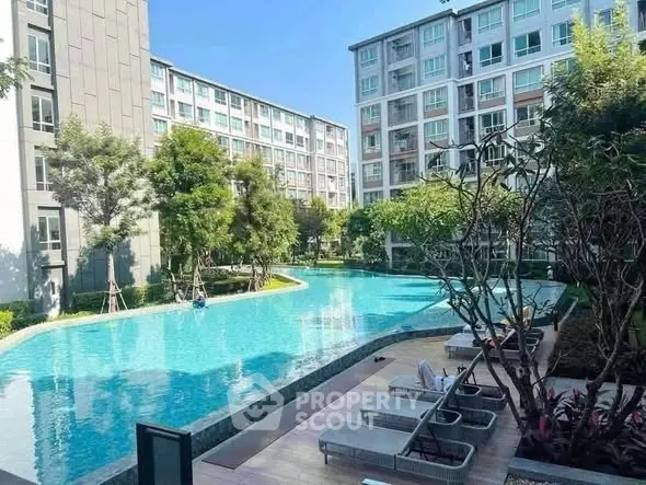 Luxurious residential complex with a stunning outdoor pool and modern architecture.