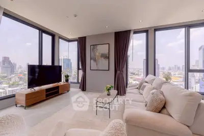 Luxurious corner unit living room with panoramic city views and modern decor.