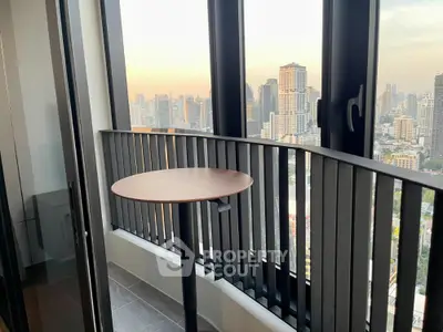 Stunning city view from modern high-rise balcony with sleek railing and stylish table.