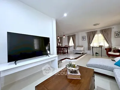 Spacious modern living room with elegant decor and open layout, perfect for family gatherings.