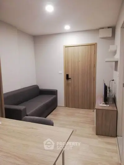 Modern living room with sleek furniture and wooden accents in a cozy apartment.