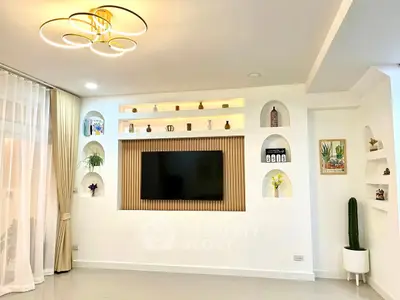 Modern living room with stylish wall decor and elegant lighting