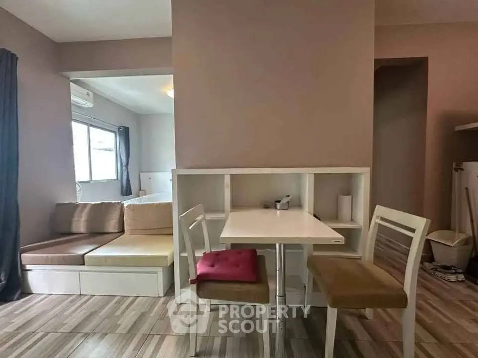 Modern living room with cozy seating and dining area, featuring stylish decor and natural light.