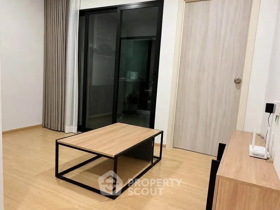 Modern living room with sleek coffee table and sliding glass doors