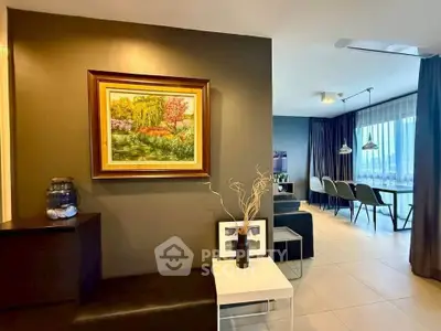 Stylish modern living room with elegant dining area and artistic decor.