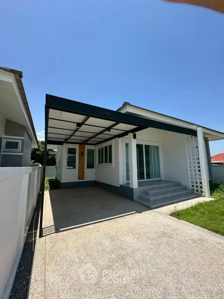 Charming single-story home with modern design and spacious driveway, perfect for family living.