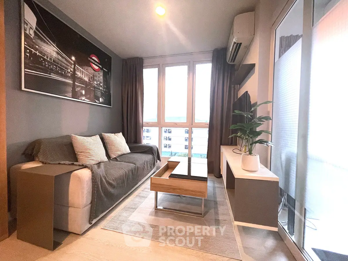 Modern living room with stylish decor and large windows for natural light.