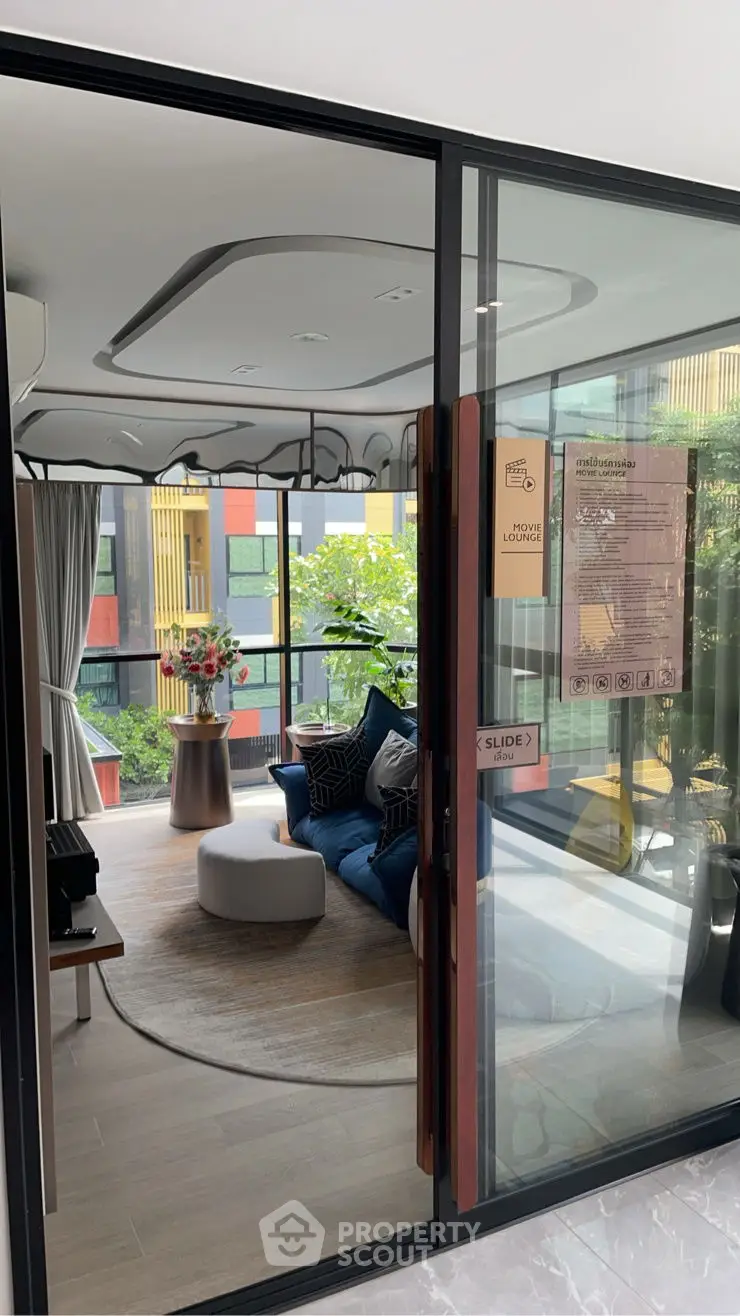 Modern living room with stylish decor and large windows overlooking vibrant exterior