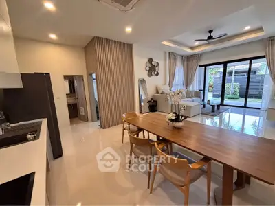 Modern open-plan living room with dining area and garden view