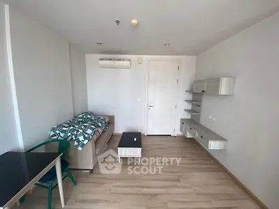 Modern living room with sleek furniture and wooden flooring in a cozy apartment.